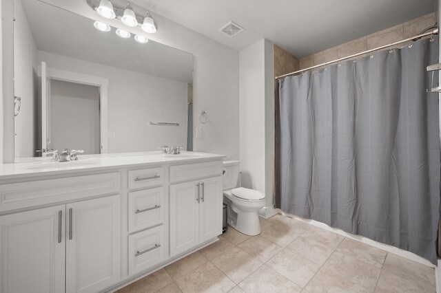 2610 Ironton Dr, Commerce Twp, MI 48382 - bathroom with toilet, double vanity, tile patterned floors, and a shower with shower curtain