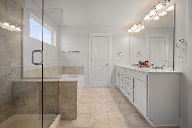 2610 Ironton Dr, Commerce Twp, MI 48382 - full bath with a stall shower, a bath, double vanity, tile patterned flooring, and baseboards