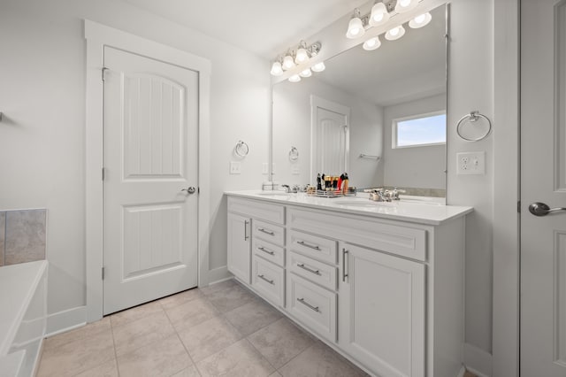 2610 Ironton Dr, Commerce Twp, MI 48382 - full bathroom with double vanity, a tub to relax in, tile patterned floors, and baseboards