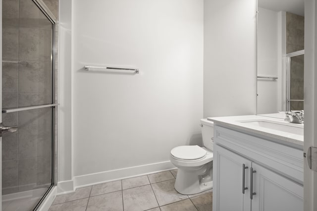 2610 Ironton Dr, Commerce Twp, MI 48382 - full bath featuring tile patterned floors, vanity, toilet, tiled shower, and baseboards
