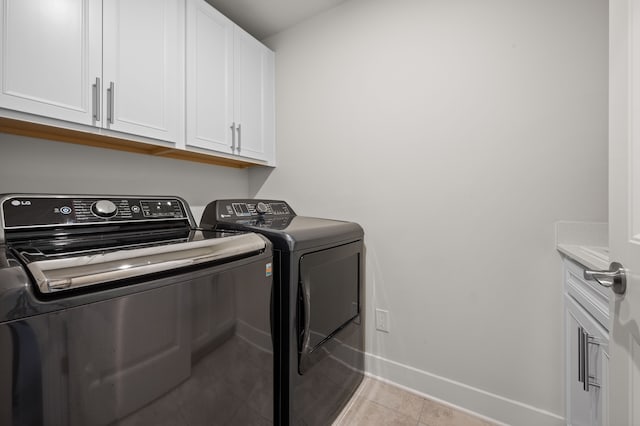 2610 Ironton Dr, Commerce Twp, MI 48382 - washroom with independent washer and dryer, baseboards, cabinet space, and light tile patterned flooring