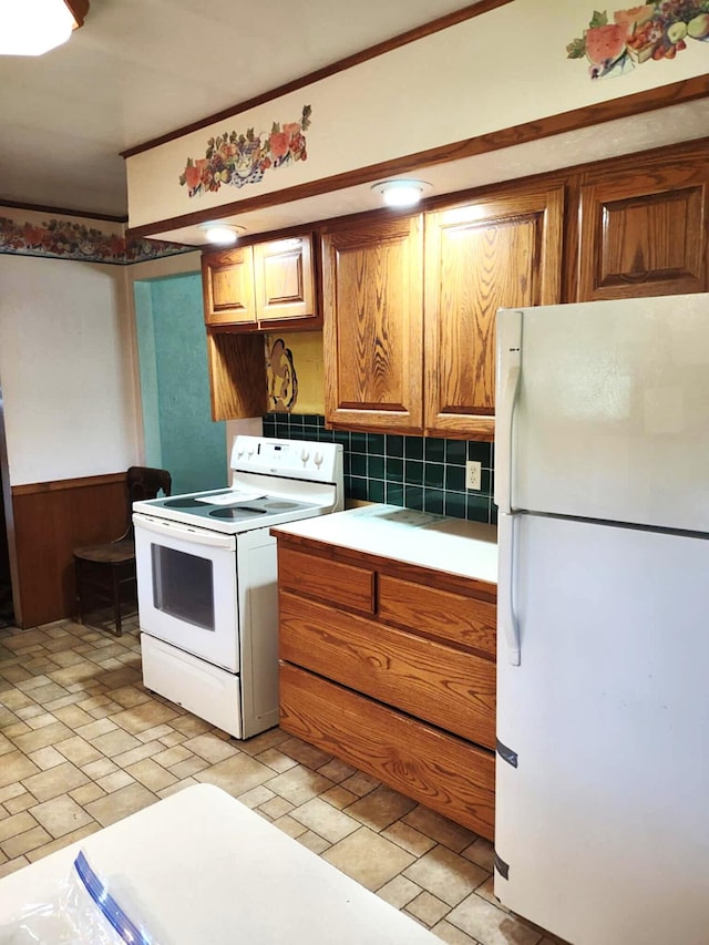10122 Jones Rd, Bellevue, MI 49021 - kitchen with white appliances, brown cabinetry, decorative backsplash, and wainscoting