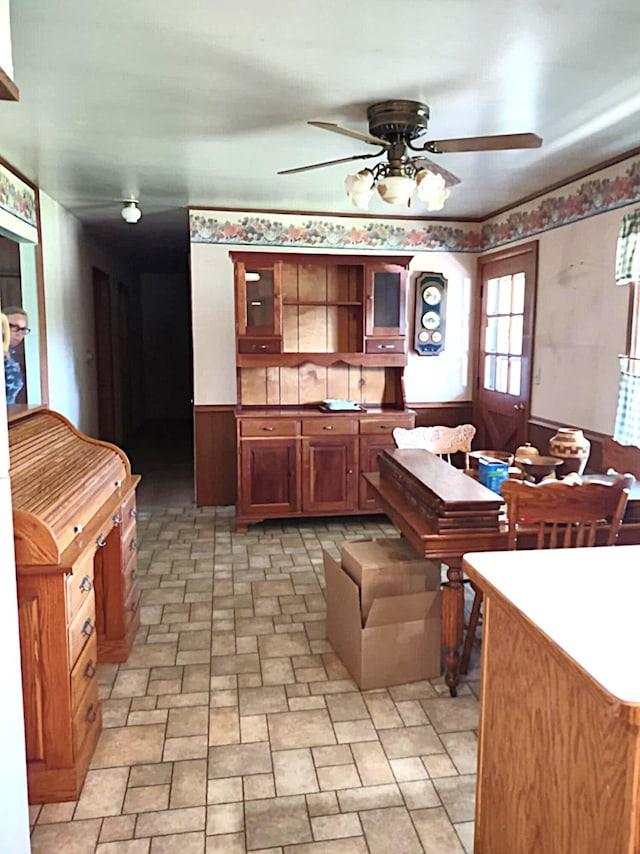 10122 Jones Rd, Bellevue, MI 49021 - kitchen featuring ceiling fan, brown cabinets, glass insert cabinets, and open shelves