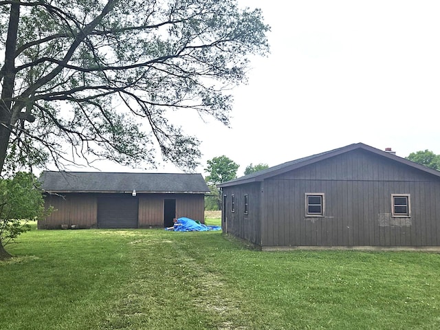 10122 Jones Rd, Bellevue, MI 49021 - view of side of home with a yard and an outdoor structure