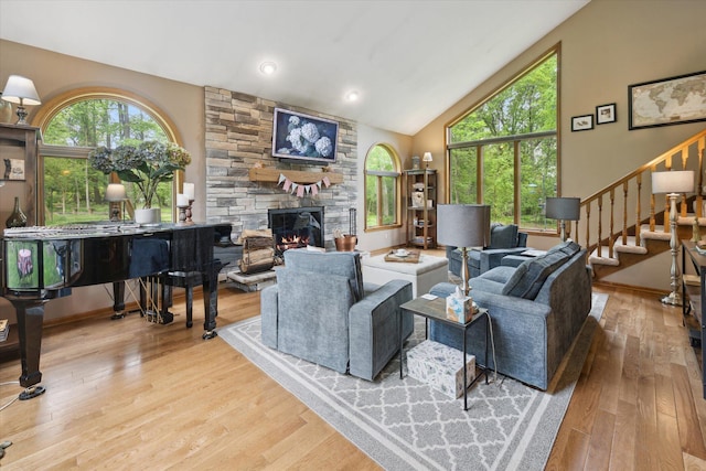3172 Shadow Brook Ln, Pinckney, MI 48169 - living area featuring a fireplace, stairway, wood finished floors, and high vaulted ceiling