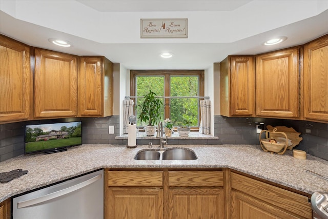 3172 Shadow Brook Ln, Pinckney, MI 48169 - kitchen with stainless steel dishwasher, a sink, tasteful backsplash, brown cabinetry, and recessed lighting