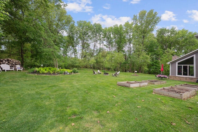 3172 Shadow Brook Ln, Pinckney, MI 48169 - view of grassy yard featuring a vegetable garden and view of wooded area