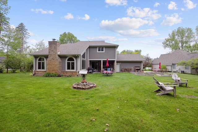 3172 Shadow Brook Ln, Pinckney, MI 48169 - rear view of house with a chimney, a yard, and a shingled roof