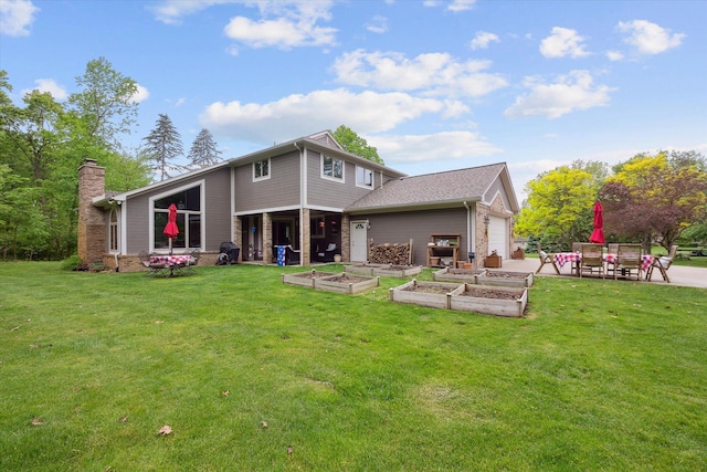 3172 Shadow Brook Ln, Pinckney, MI 48169 - back of house featuring a vegetable garden, a yard, a garage, and a chimney