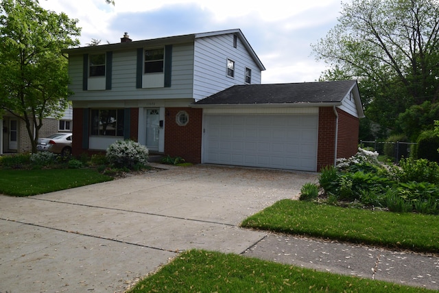 15372 Michael St, Taylor, MI 48180 - colonial-style house featuring brick siding, driveway, a chimney, and an attached garage