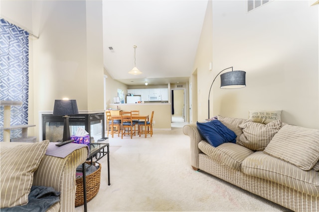 760 Olde English Cir, Howell, MI 48855 - living room featuring light colored carpet, high vaulted ceiling, and baseboards