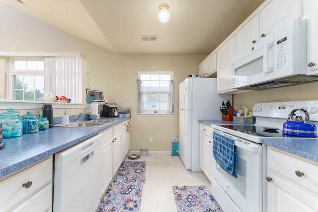 760 Olde English Cir, Howell, MI 48855 - kitchen with white appliances, a sink, white cabinetry, lofted ceiling, and baseboards