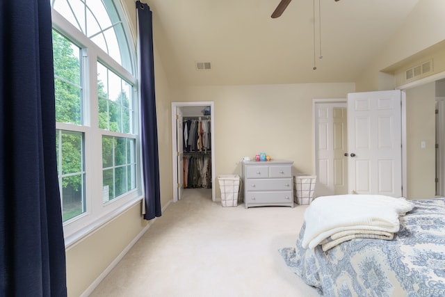 760 Olde English Cir, Howell, MI 48855 - bedroom featuring multiple windows, carpet flooring, lofted ceiling, ceiling fan, and a walk in closet
