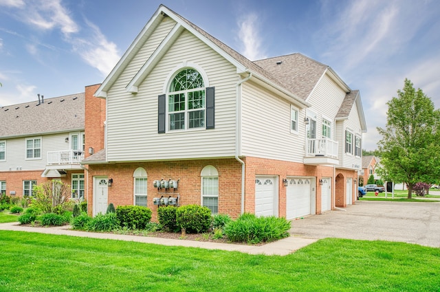 760 Olde English Cir, Howell, MI 48855 - view of front of home featuring driveway, an attached garage, a front yard, and brick siding