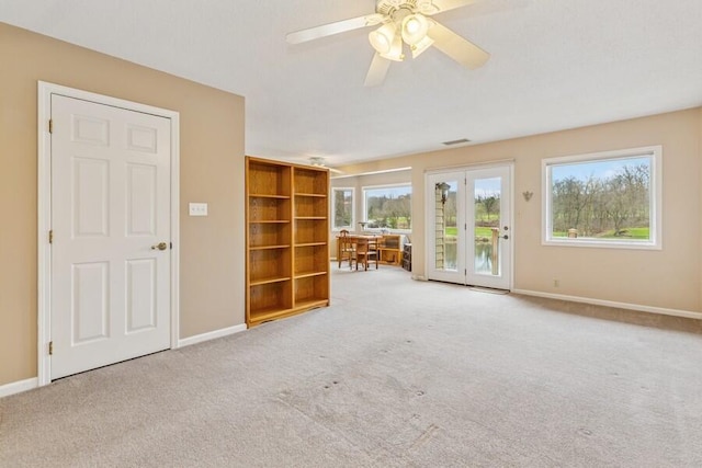 2942 White Oaks Ln, Buchanan, MI 49107 - unfurnished living room with carpet, baseboards, and a ceiling fan