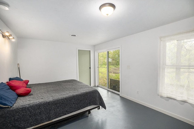 3921 Wildwood Ave, Bitely, MI 49309 - bedroom with finished concrete flooring, access to outside, and baseboards