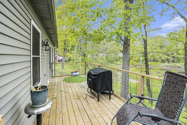 3921 Wildwood Ave, Bitely, MI 49309 - wooden deck with area for grilling and view of wooded area