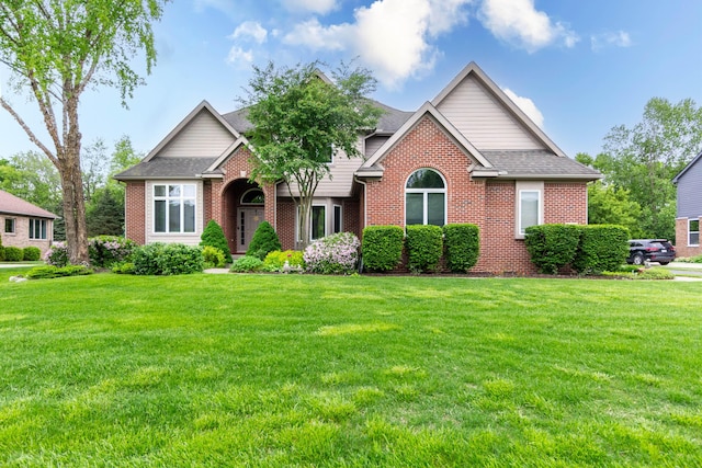 7009 Suncrest Dr, Saline, MI 48176 - view of front facade featuring brick siding, a front yard, and roof with shingles