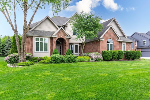 7009 Suncrest Dr, Saline, MI 48176 - traditional home featuring brick siding, a front lawn, and roof with shingles