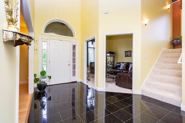 7009 Suncrest Dr, Saline, MI 48176 - foyer featuring baseboards, healthy amount of natural light, a towering ceiling, stairway, and granite tiled floors