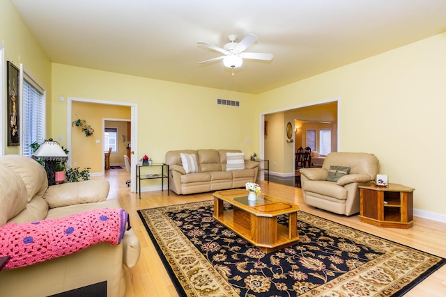 7009 Suncrest Dr, Saline, MI 48176 - living room featuring wood finished floors, a ceiling fan, and baseboards