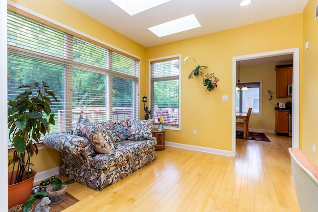 7009 Suncrest Dr, Saline, MI 48176 - living area featuring a skylight, light wood-type flooring, and baseboards