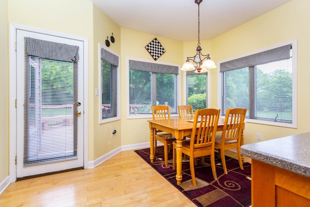 7009 Suncrest Dr, Saline, MI 48176 - dining room with a chandelier, light wood-type flooring, baseboards, and healthy amount of natural light