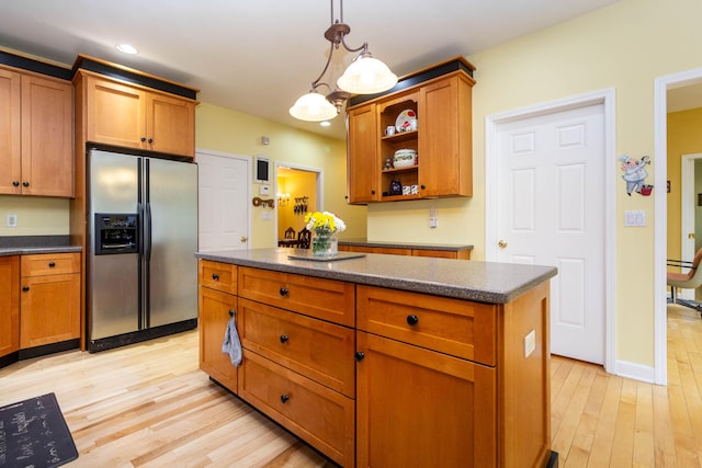 7009 Suncrest Dr, Saline, MI 48176 - kitchen with stainless steel fridge with ice dispenser, light wood-style flooring, brown cabinetry, open shelves, and a center island