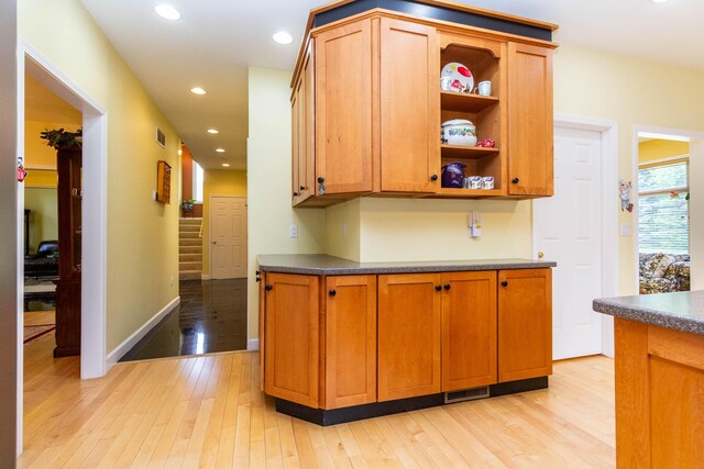 7009 Suncrest Dr, Saline, MI 48176 - kitchen with dark countertops, light wood-style floors, recessed lighting, baseboards, and open shelves