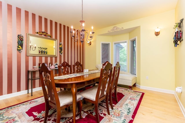7009 Suncrest Dr, Saline, MI 48176 - dining space with light wood-type flooring, a chandelier, baseboards, and wallpapered walls