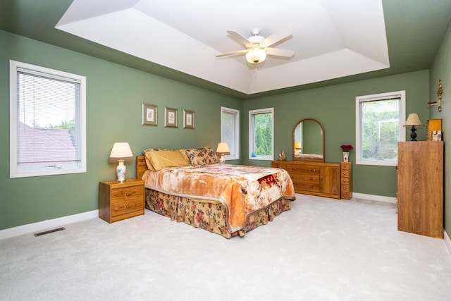 7009 Suncrest Dr, Saline, MI 48176 - bedroom featuring a tray ceiling, carpet flooring, baseboards, and a ceiling fan