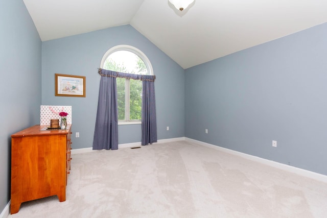 7009 Suncrest Dr, Saline, MI 48176 - spare room with light carpet, vaulted ceiling, and baseboards
