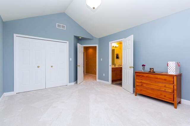 7009 Suncrest Dr, Saline, MI 48176 - bedroom featuring light carpet, vaulted ceiling, a closet, baseboards, and connected bathroom