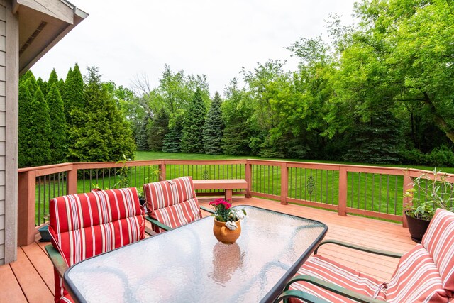 7009 Suncrest Dr, Saline, MI 48176 - wooden deck featuring outdoor dining space and a lawn