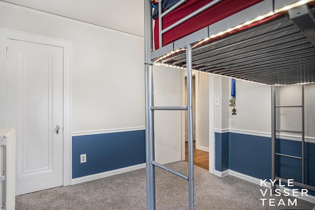 1058 Eastwood Ave SE, East Grand Rapids, MI 49506 - unfurnished bedroom featuring carpet floors, baseboards, radiator heating unit, and ornamental molding