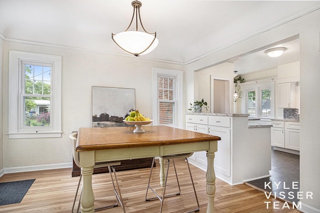 1058 Eastwood Ave SE, East Grand Rapids, MI 49506 - dining area with healthy amount of natural light, light wood-type flooring, and baseboards