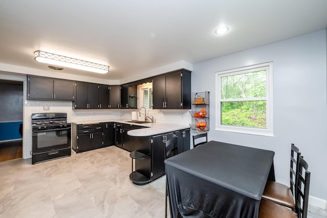 1402 Niles Buchanan Rd, Niles, MI 49120 - kitchen featuring black gas stove, light countertops, decorative backsplash, and a sink