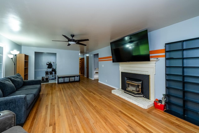 1402 Niles Buchanan Rd, Niles, MI 49120 - living room with wood finished floors, ceiling fan, baseboards, and a brick fireplace