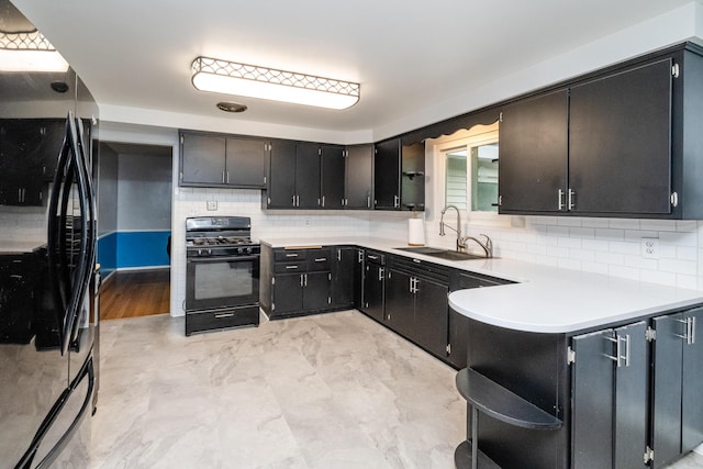 1402 Niles Buchanan Rd, Niles, MI 49120 - kitchen featuring black appliances, a sink, backsplash, light countertops, and a peninsula