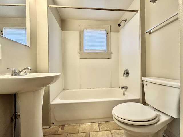 1837 Franklin St, Muskegon, MI 49441 - bathroom with toilet, shower / bathtub combination, stone finish floors, and a sink