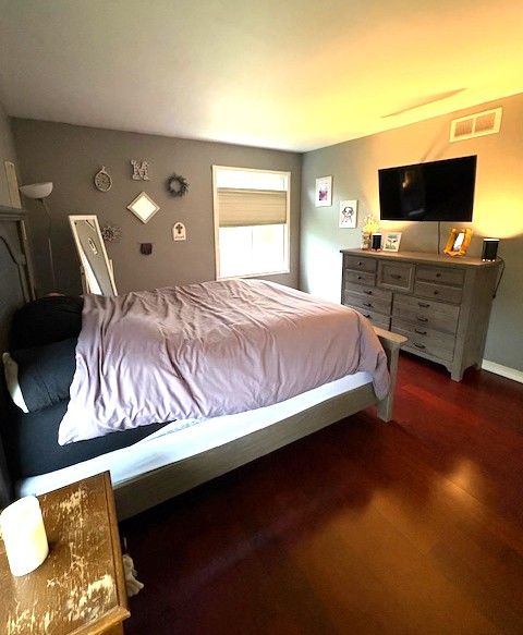 1376 Leisure Dr, Flint, MI 48507 - bedroom with dark wood-style floors and baseboards