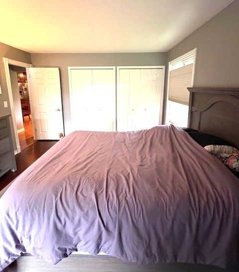 1376 Leisure Dr, Flint, MI 48507 - bedroom with two closets and dark wood finished floors