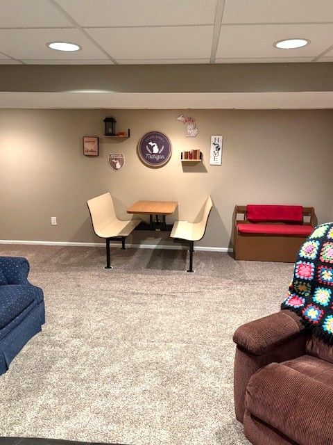 1376 Leisure Dr, Flint, MI 48507 - carpeted living room with baseboards, a paneled ceiling, and recessed lighting