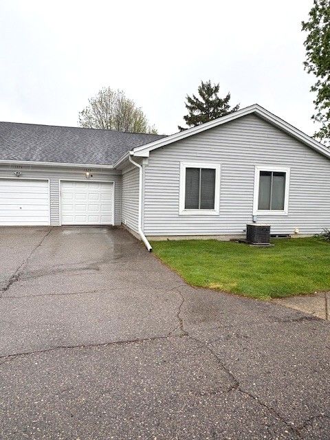 1376 Leisure Dr, Flint, MI 48507 - ranch-style home with a garage, asphalt driveway, and a front yard