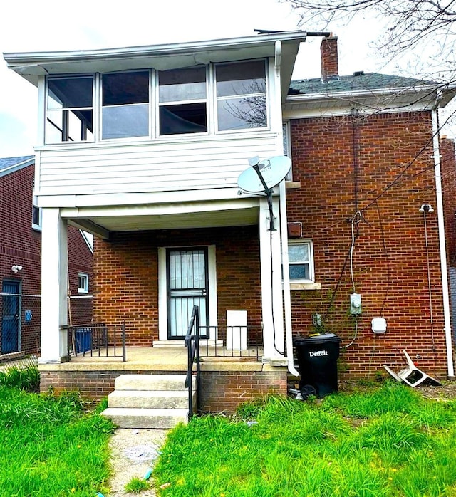 13639 Mecca St, Detroit, MI 48227 - rear view of house with brick siding, a chimney, and a porch