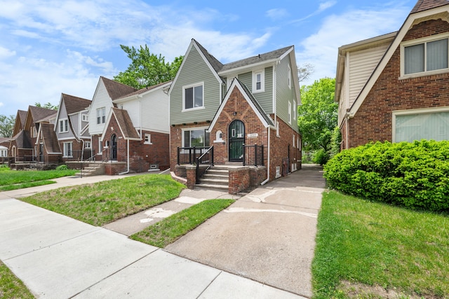 18929 Santa Rosa Dr, Detroit, MI 48221 - tudor home featuring brick siding, a residential view, and a front yard