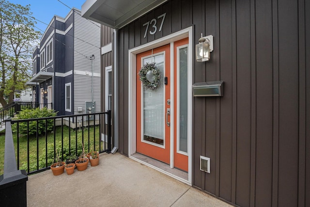 737 Bates St SE, Grand Rapids, MI 49503 - doorway to property with board and batten siding
