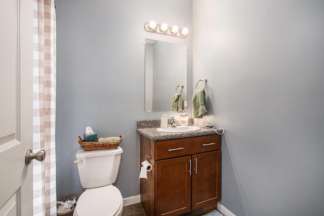 737 Bates St SE, Grand Rapids, MI 49503 - bathroom featuring vanity, toilet, and baseboards