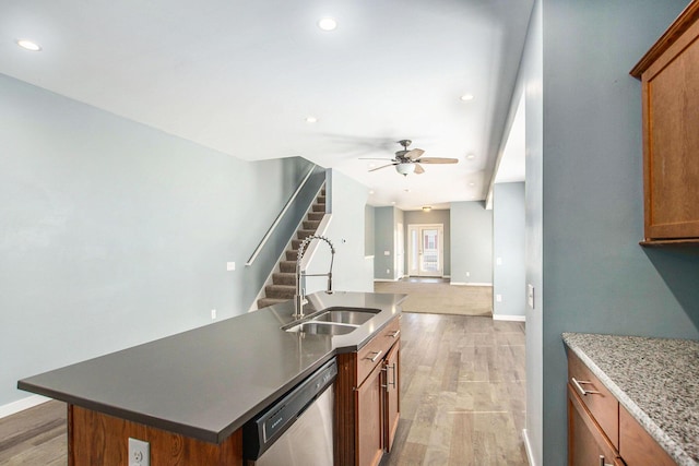 737 Bates St SE, Grand Rapids, MI 49503 - kitchen featuring dishwasher, a ceiling fan, brown cabinetry, open floor plan, and light wood-style flooring