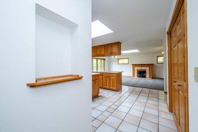 5142 Becht Rd, Coloma, MI 49038 - unfurnished living room featuring a skylight, a fireplace, and light tile patterned floors